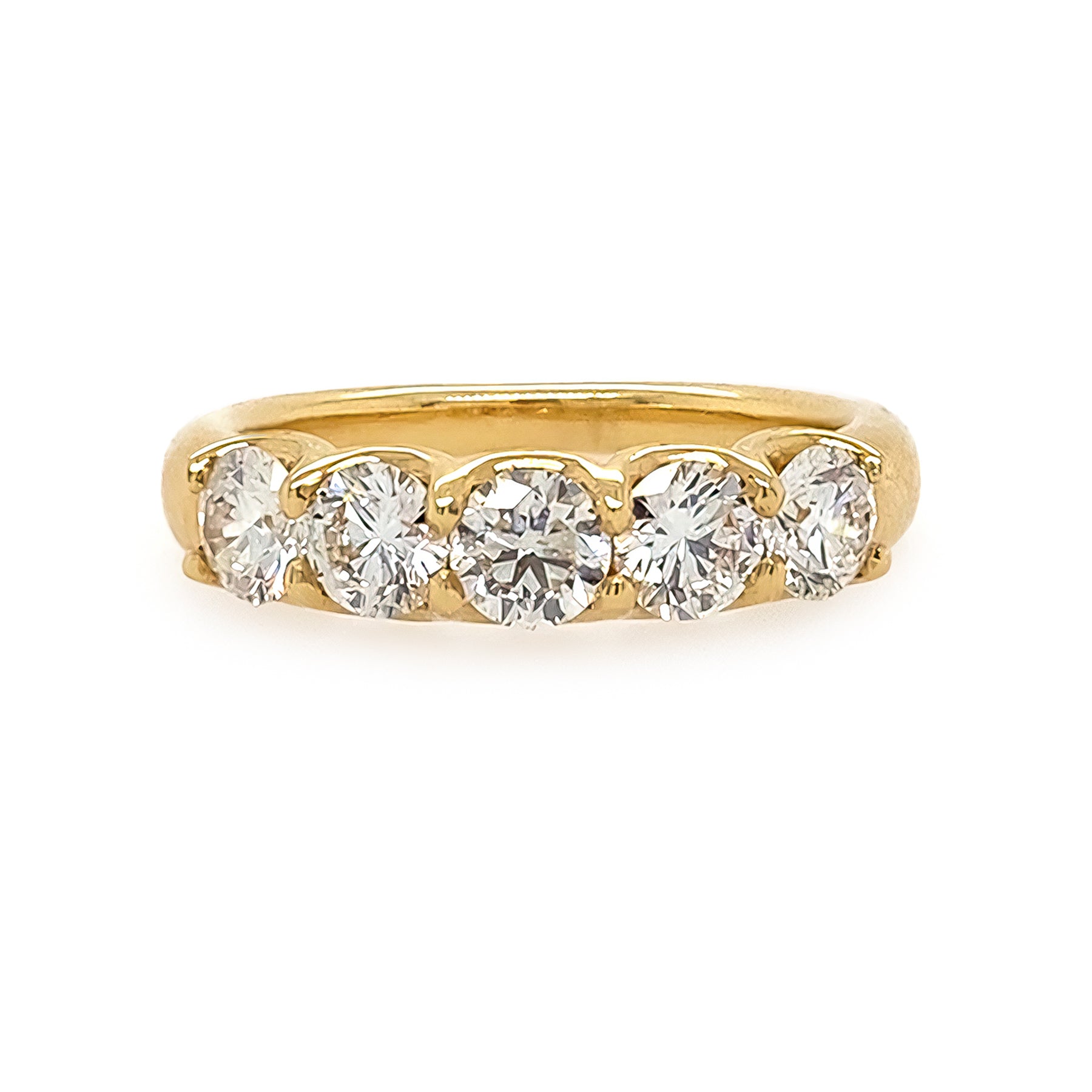 18K Gold ring with five diamonds on a white background