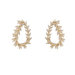 Pair of 18K gold drop earrings with diamond stones on a white background