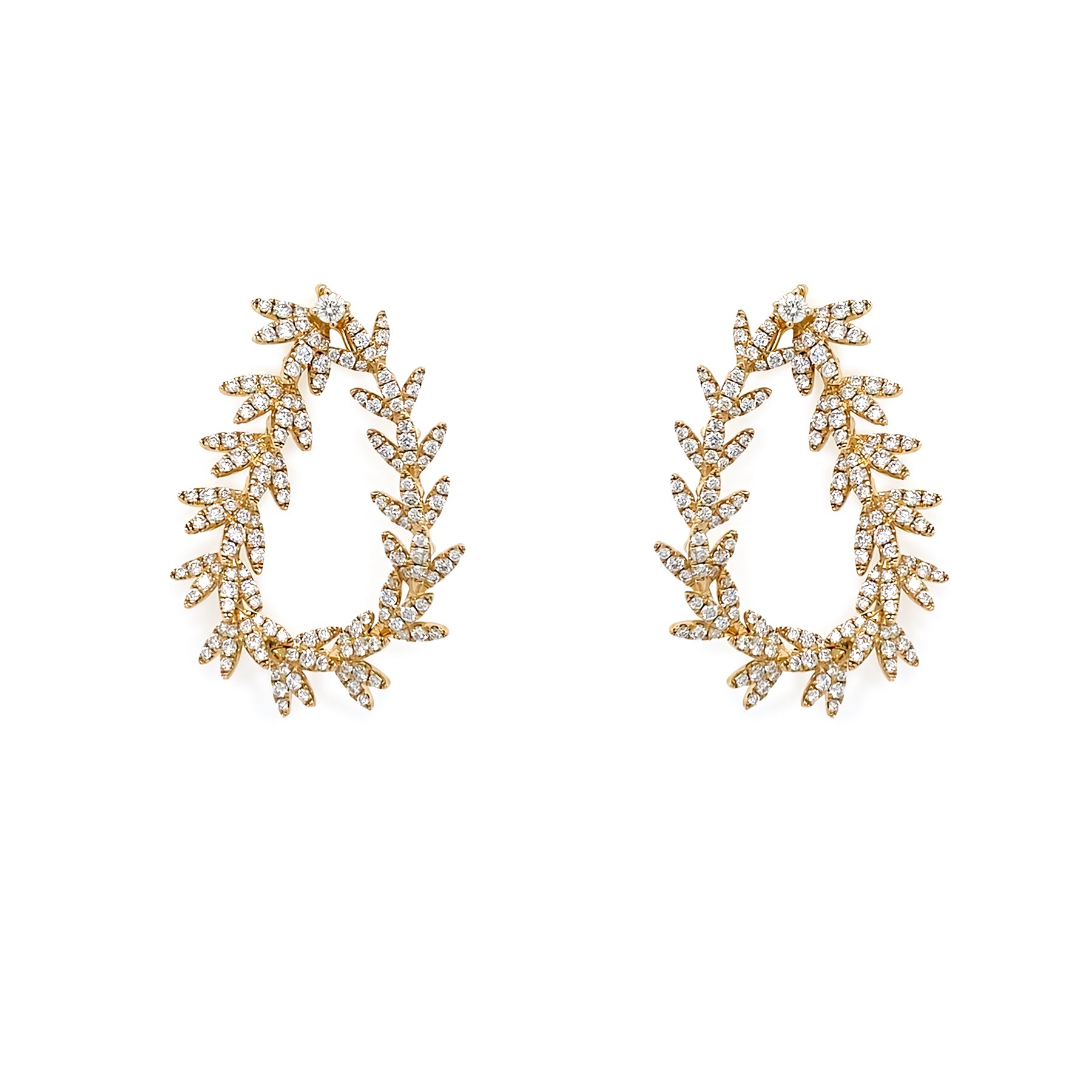 Pair of 18K gold drop earrings with diamond stones on a white background