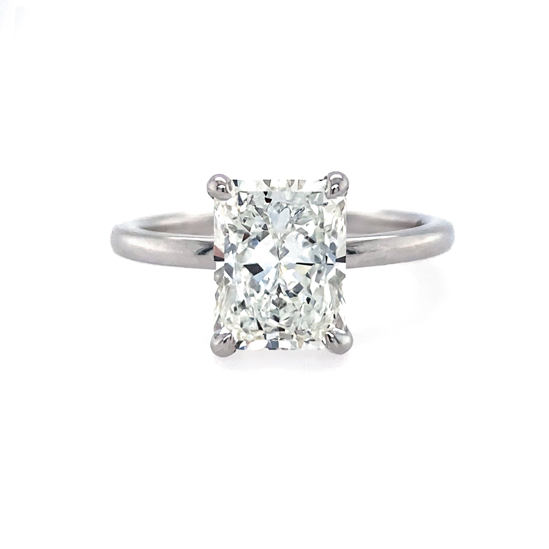 An 18K white gold radiant cut diamond ring with a G-H SI2 GIA certification, displayed on a white background.