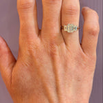 woman wearing 18K white gold emerald cut 3 stone diamond ring