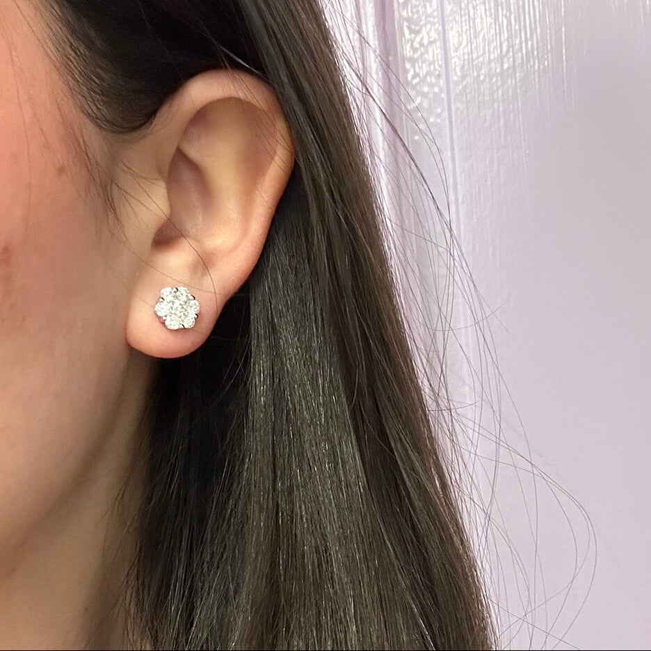 woman wearing 18K white gold diamond cluster earrings