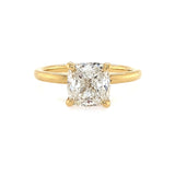An 18K yellow gold cushion cut diamond ring with a clear, certified diamond in a gold band.