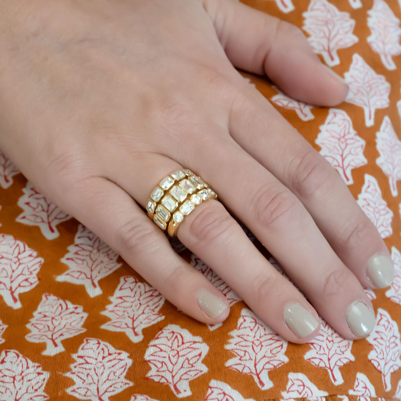 Woman wearing 18K gold baguette bezel diamond ring