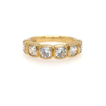 An 18K yellow gold bezel set band ring with six round diamond stones.