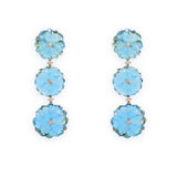 A pair of 18K yellow gold dangle earrings featuring blue topaz flowers with diamond accents.
