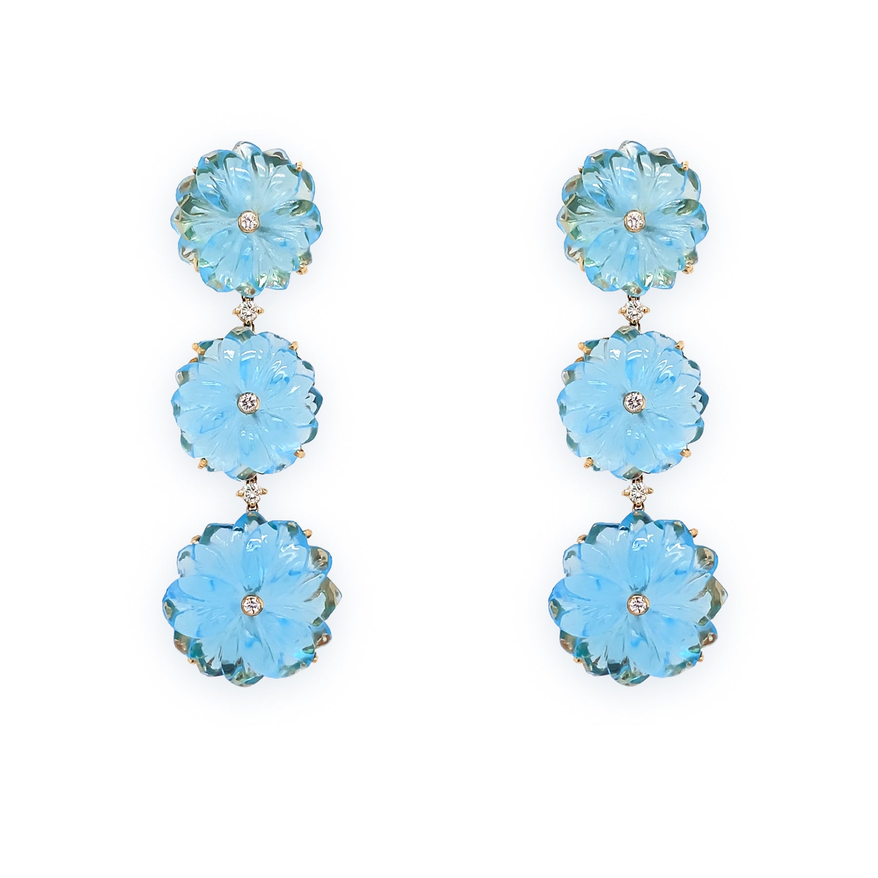 A pair of 18K yellow gold dangle earrings featuring blue topaz flowers with diamond accents.