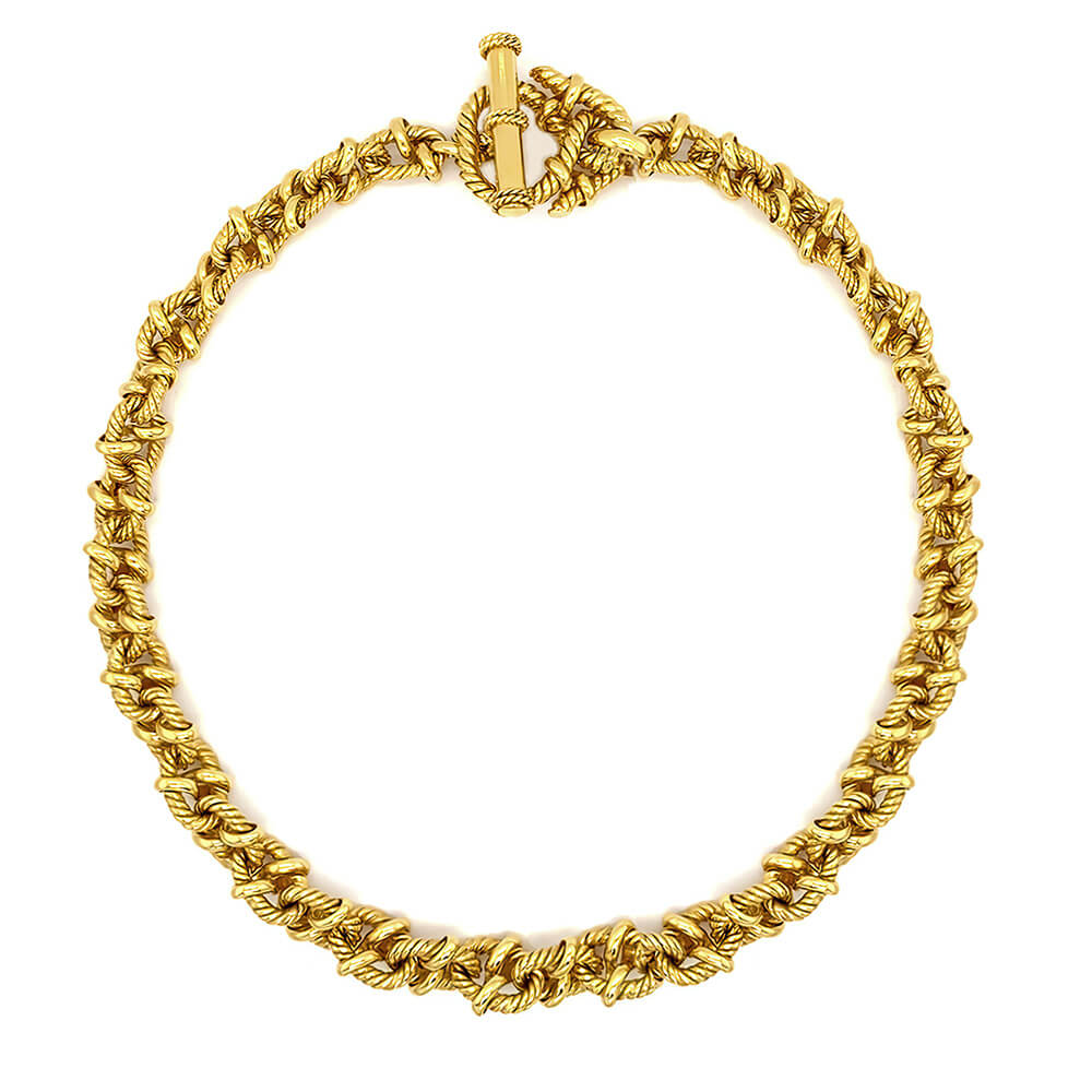 An 18K yellow gold chain necklace with a textured, rope-like twisted design and a matching toggle clasp, shown on a plain white background.