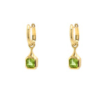 18K Gold drop earrings with green Peridot gemstones on a white background