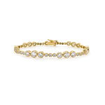 An 18K yellow gold tennis bracelet with diamond bezels evenly spaced along its length.