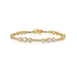 An 18K yellow gold tennis bracelet with diamond bezels evenly spaced along its length.