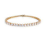 An 18K yellow gold diamond tennis bracelet with a 43  linked round-cut diamonds.