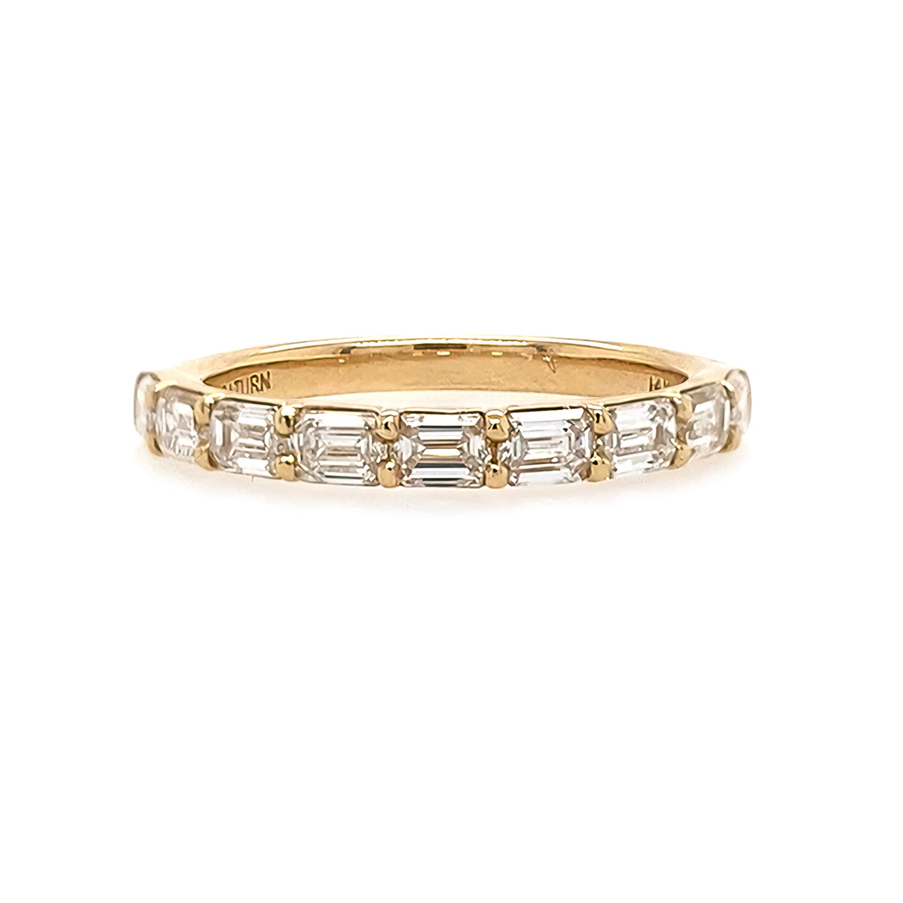 18K Gold ring with emerald-cut diamonds on a white background