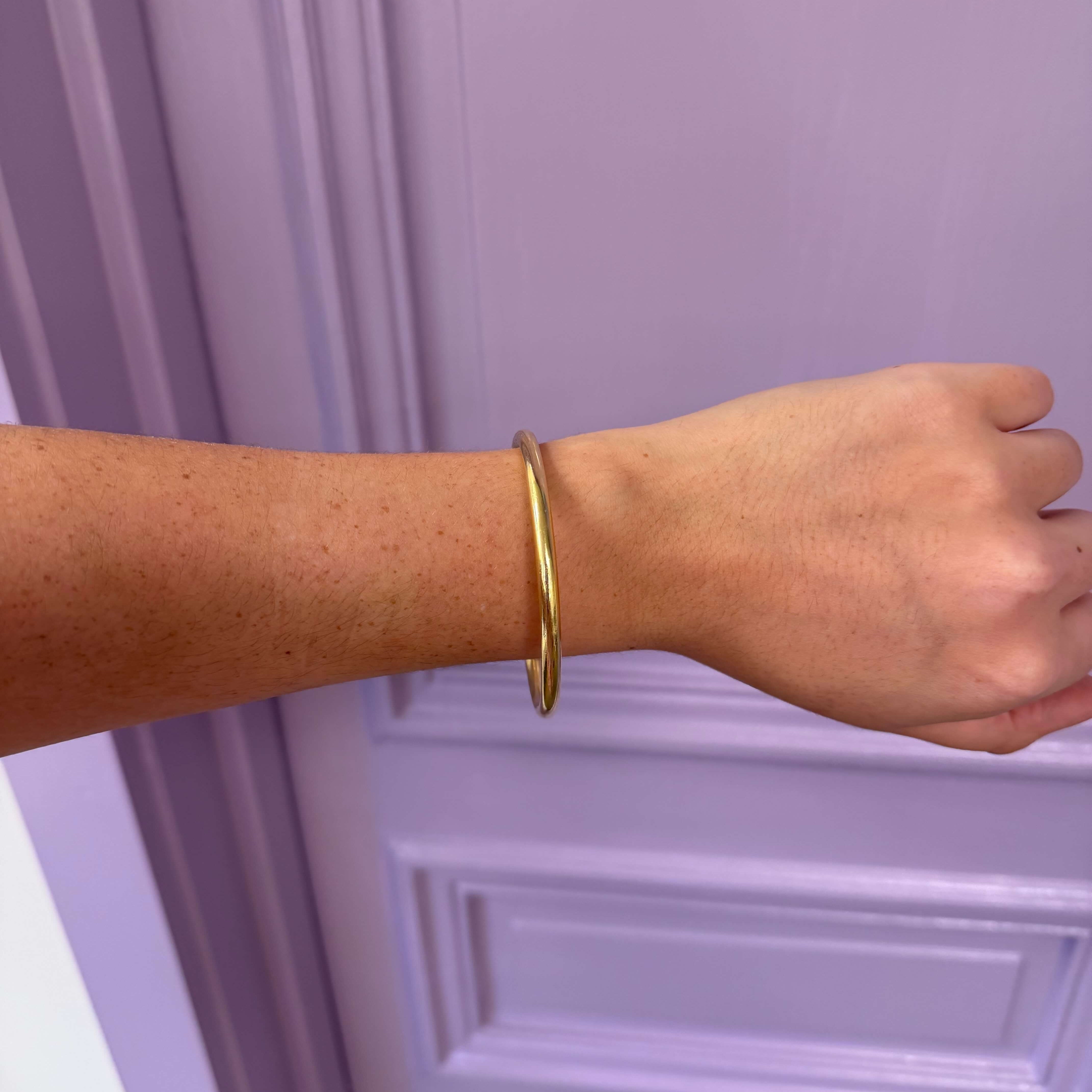 gold bangle on wrist