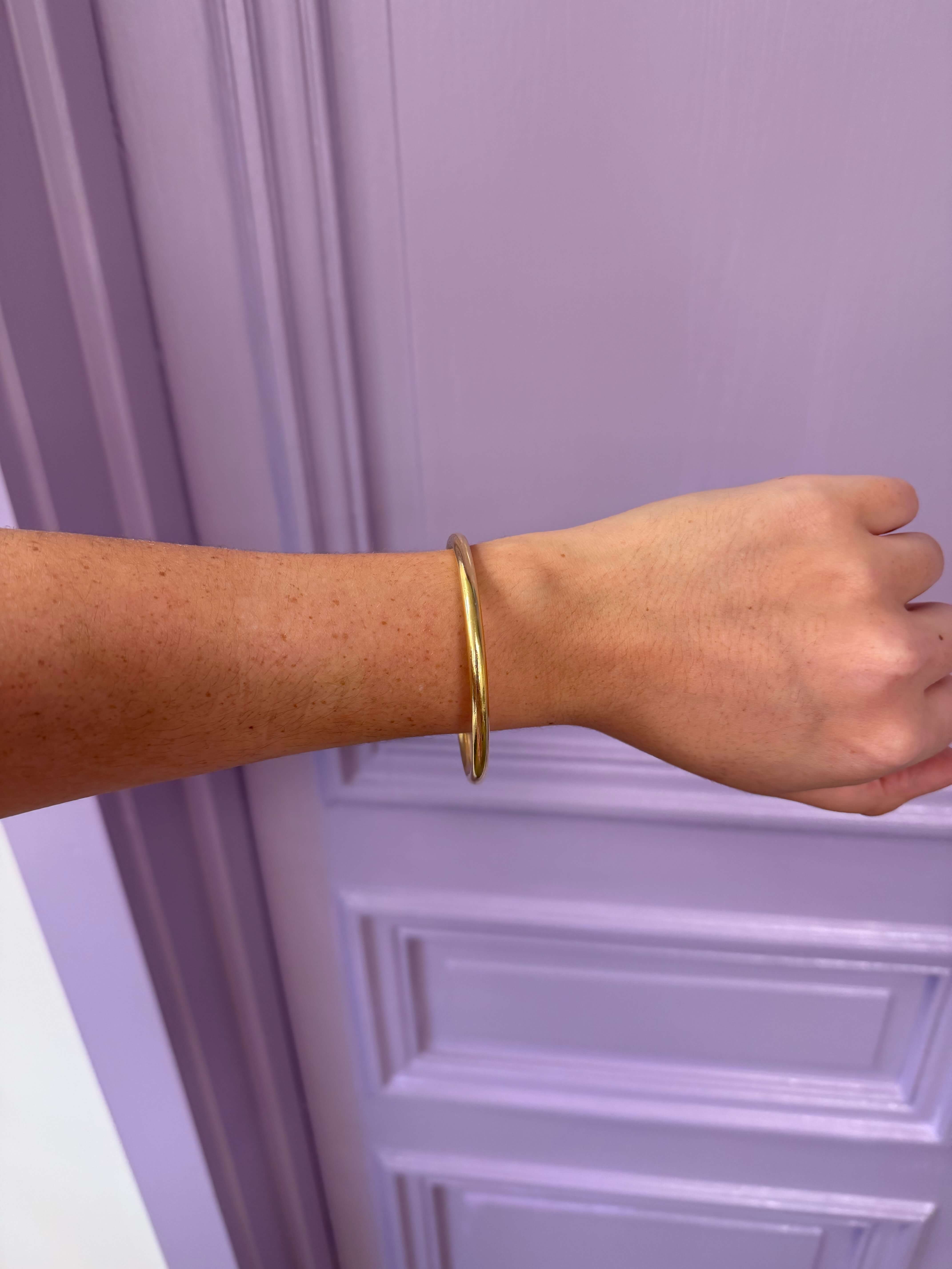 gold bangle on wrist