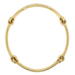 A polished 18k yellow gold necklace with four decorative knot-like accents spaced evenly around the circular band, shown on a plain white background.