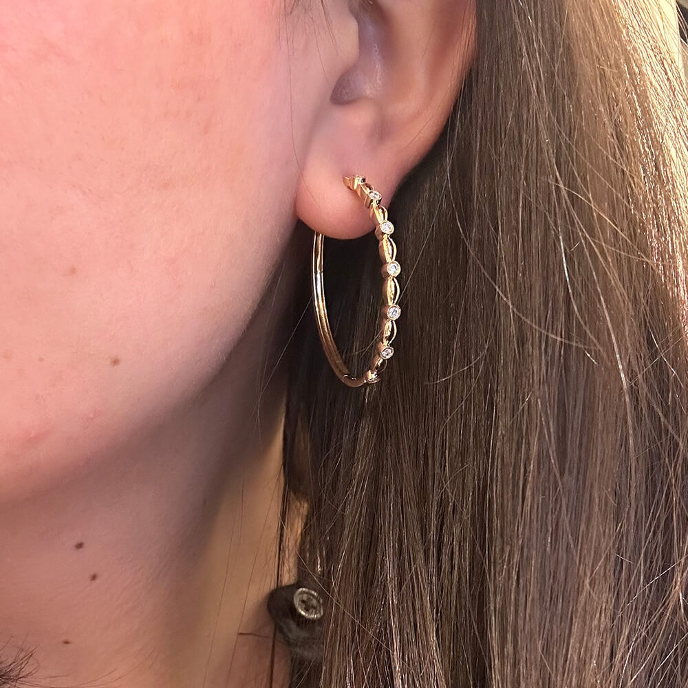 woman wearing 18K yellow gold Gabriel & Co hoops