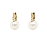 Pair of pearl earrings with diamond accents on a white background