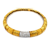 Gold bracelet with a diamond accent on a white background