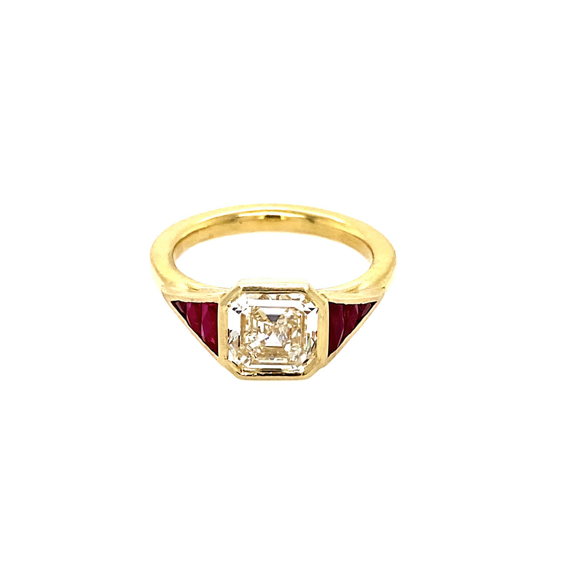 An 18k yellow gold Asscher cut diamond and ruby ring 