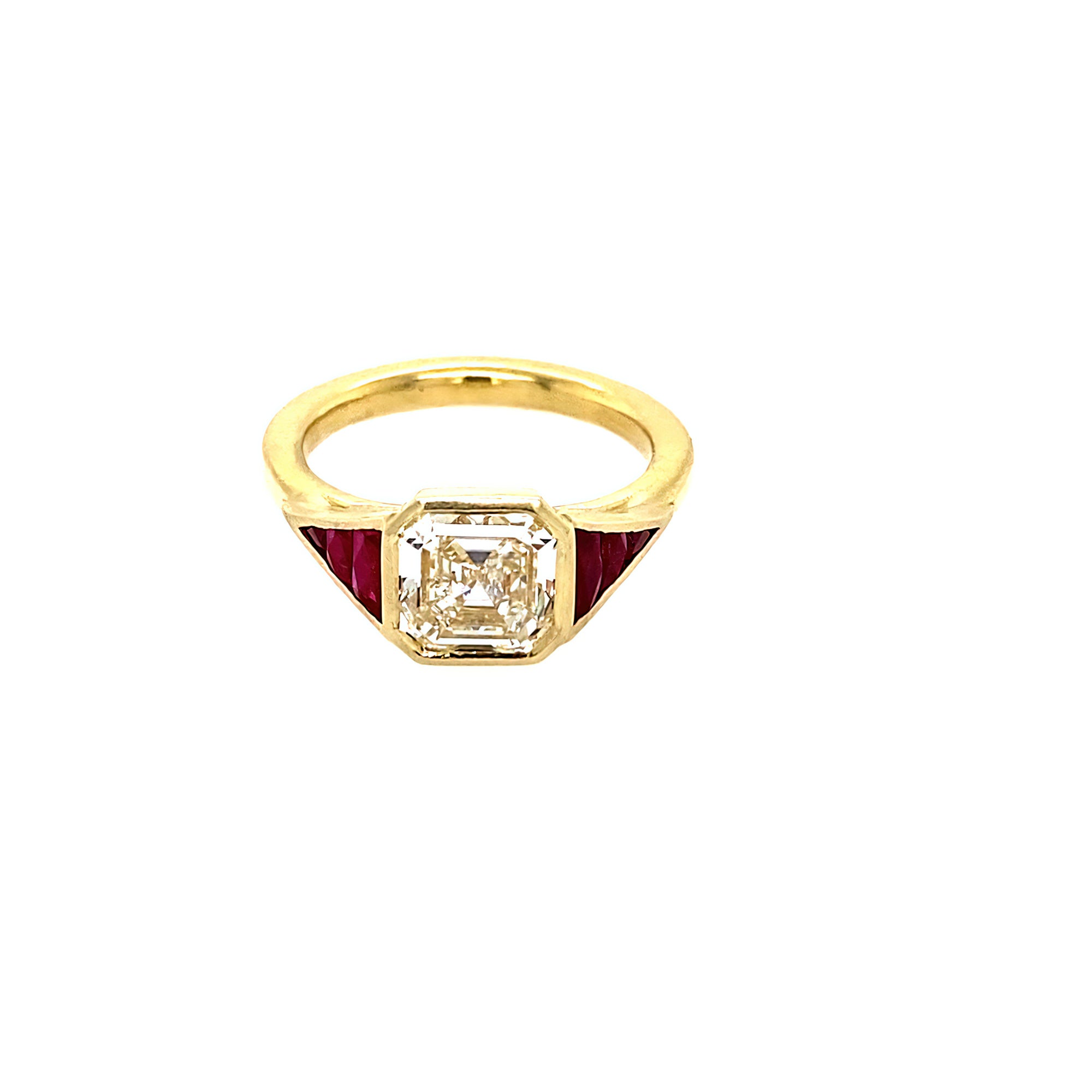 An 18k yellow gold Asscher cut diamond and ruby ring 