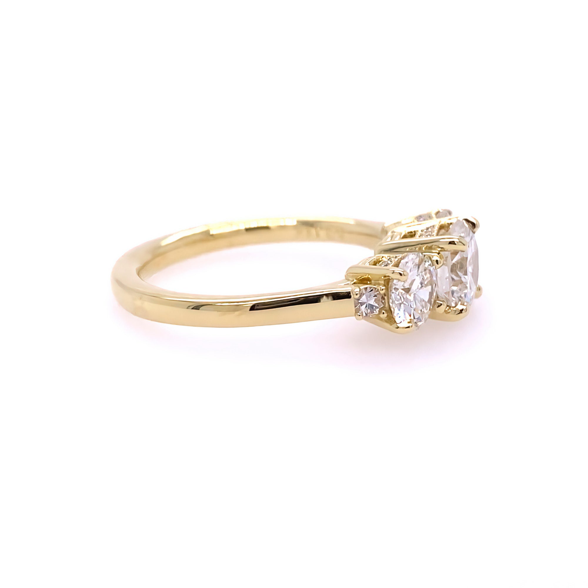 Side view of 18K gold ring with 3 diamond stones