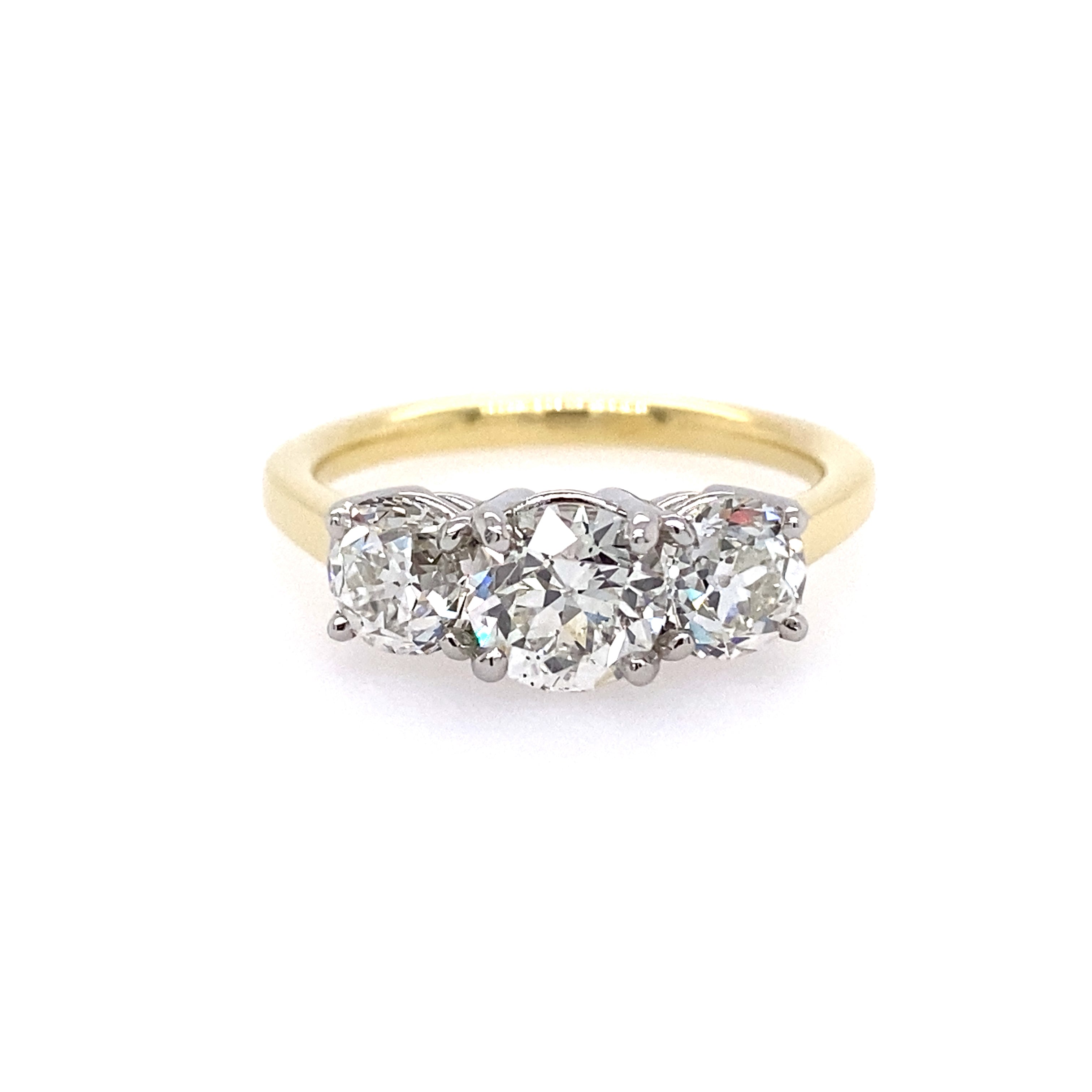 An 18k yellow gold band with three round diamonds set in platinum
