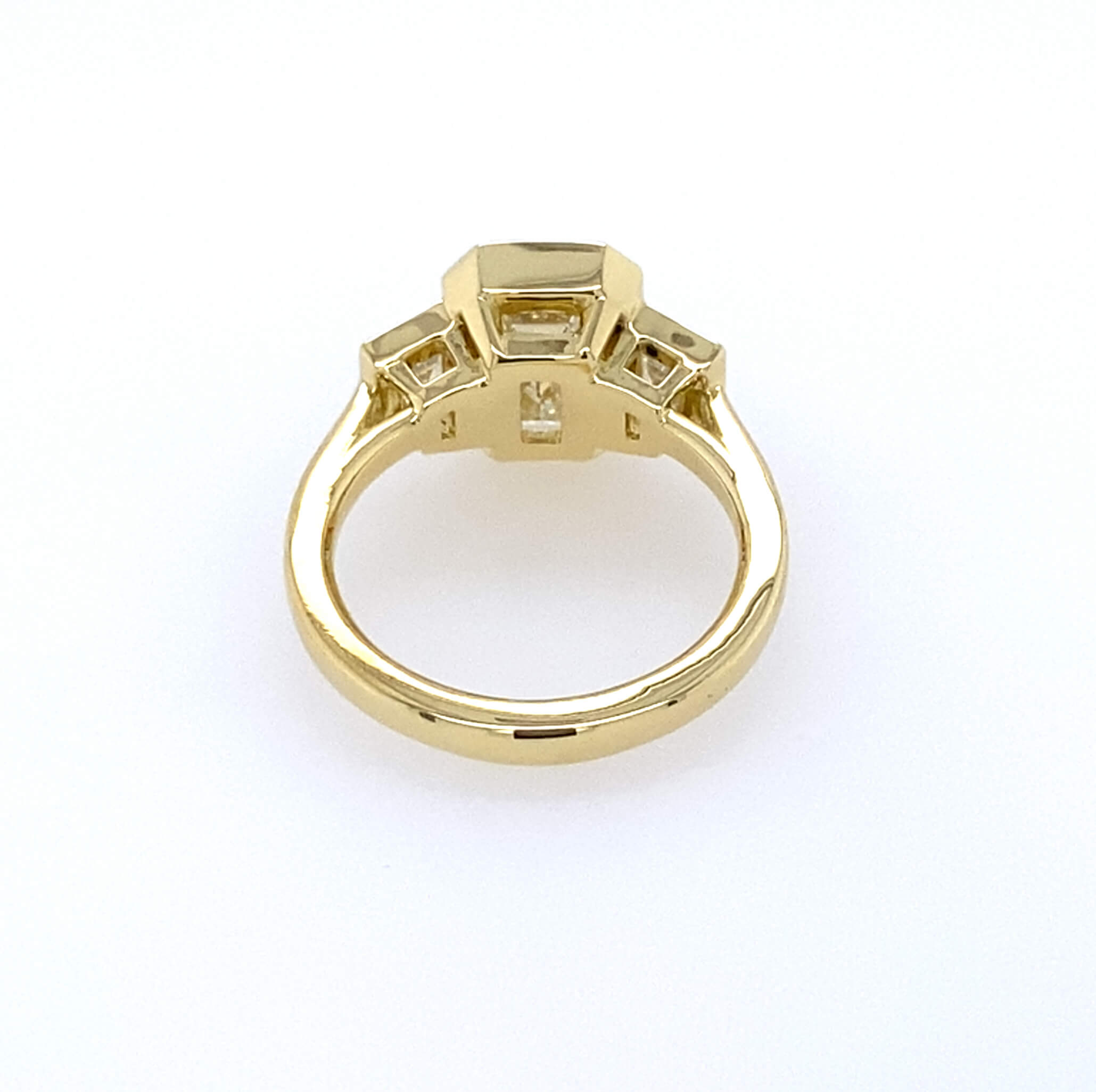 Back View 18k yellow gold bezel set emerald cut engagement ring with trapezoids side stones 