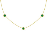 18K Gold necklace with green emerald gemstones on a white background