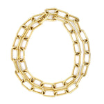 An 18K gold chain necklace with large, elongated oval links, arranged in a loose double circle on a plain white background.