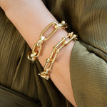 woman wearing 18k yellow gold link bracelets offered by Laura Pearce Ltd.