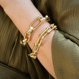 woman wearing 18k yellow gold link bracelets offered by Laura Pearce Ltd.