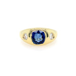 front view yellow Gold ring with a blue sapphire and diamond side stones