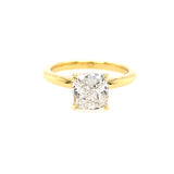 An 18kt yellow gold ring with a cushion cut diamond in the center.