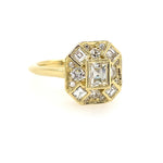 An 18kt yellow gold ring with a central square-shaped diamond surrounded by smaller square and round diamonds 