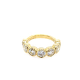 An 18kt yellow gold bezel set diamond band ring with 7 diamonds.