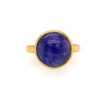 A 22K yellow gold ring with a tanzanite cabochon in the center, displayed against a white background.
