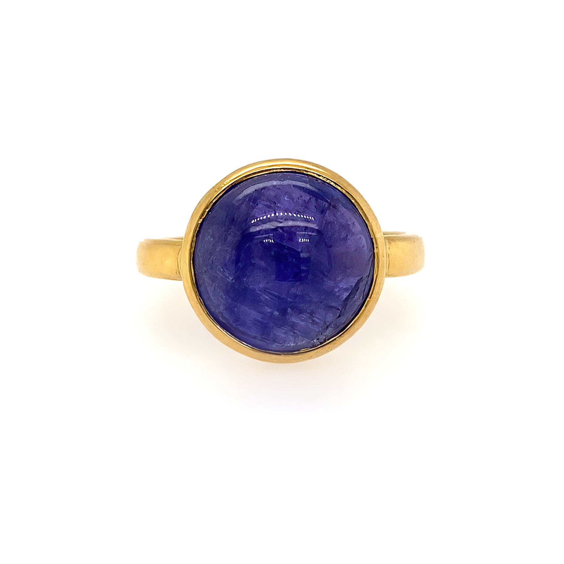 A 22K yellow gold ring with a tanzanite cabochon in the center, displayed against a white background.
