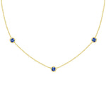 18K Gold necklace with three sapphire gemstones on a white background
