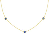 18K Gold necklace with three sapphire gemstones on a white background