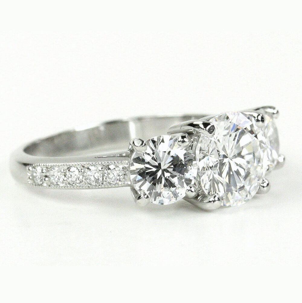 custom-designed platinum three stone Diamond ring with side pave diamonds on the band created by Laura Pearce