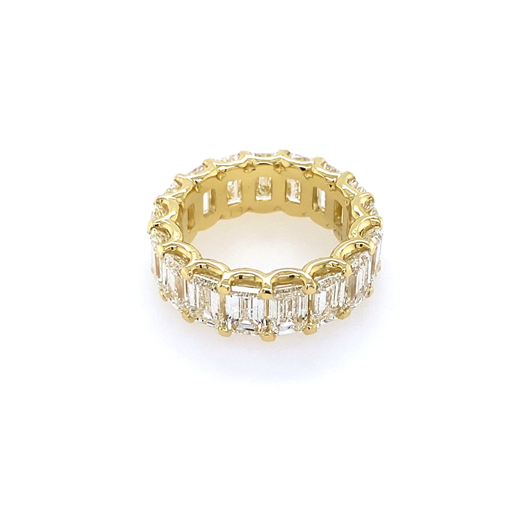 Side view of 18k yg eternity band with emerald-cut diamonds 