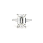 Diamond ring with emerald-cut diamond on a white background