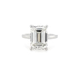 Diamond ring with emerald-cut diamond on a white background