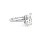 Diamond ring with emerald cut diamond on a white background