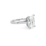 Diamond ring with emerald cut diamond on a white background