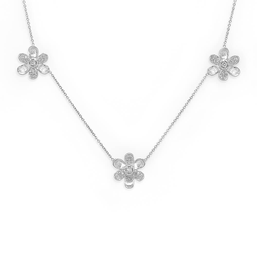 An 18K white gold necklace featuring three flower motifs on a delicate chain, displayed against a solid white background.