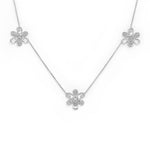 An 18K white gold necklace featuring three flower motifs on a delicate chain, displayed against a solid white background.