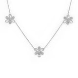 An 18K white gold necklace featuring three flower motifs on a delicate chain, displayed against a solid white background.