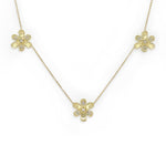 A delicate 18K yellow gold chain necklace featuring three small flower-shaped pendants, each adorned with tiny clear diamonds, displayed on a clean white background.